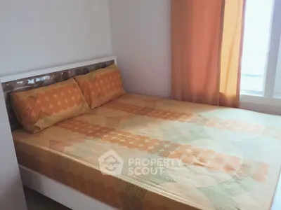 Cozy bedroom with orange-themed decor and natural light