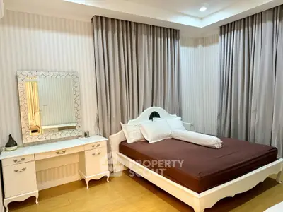 Elegant bedroom with classic white furniture and cozy ambiance