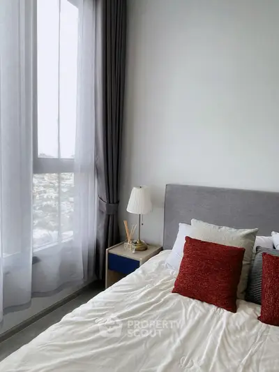 Modern bedroom with large window and stylish decor