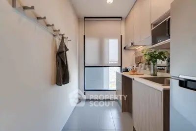 Modern kitchen with sleek cabinetry and natural light, perfect for culinary enthusiasts.