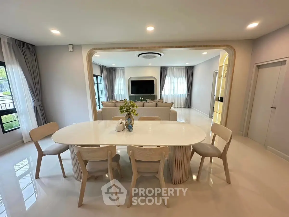 Spacious modern living room with elegant dining area and large windows