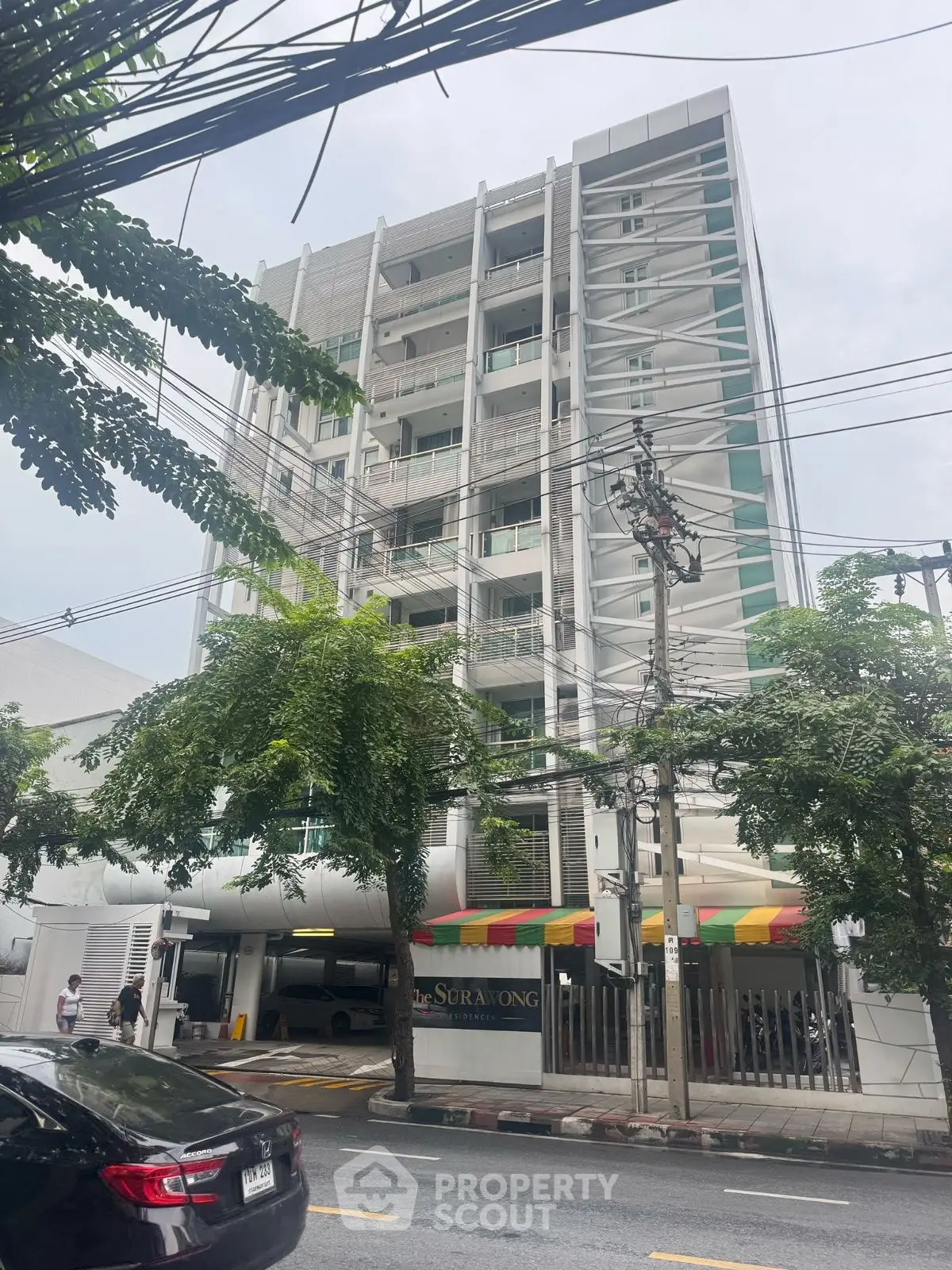 Modern multi-story building with unique architectural design and street view