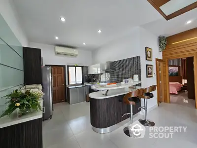 Modern kitchen with sleek design and breakfast bar in stylish home