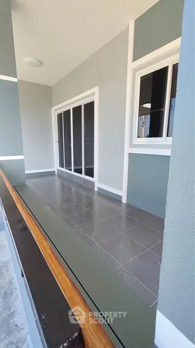 Spacious balcony with modern sliding doors and elegant tile flooring