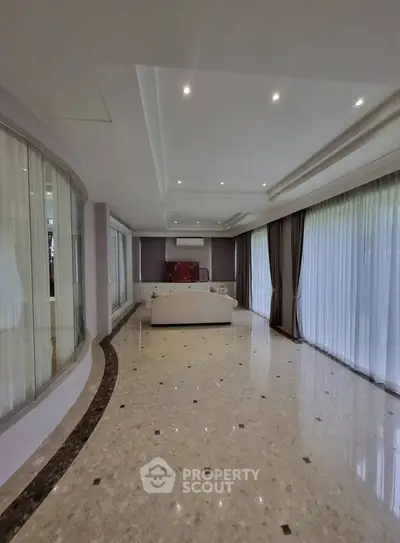 Spacious living room with elegant marble flooring and large windows