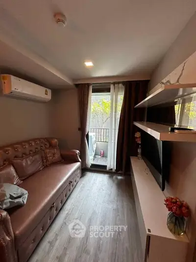 Cozy living room with modern decor and balcony view