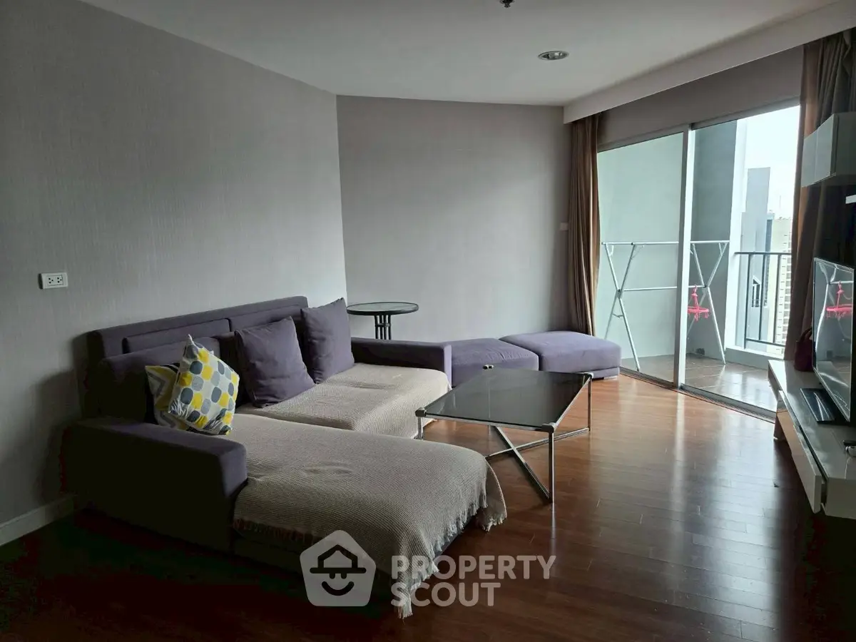 Spacious living room with modern furniture and balcony access