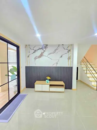 Modern living room with sleek design and elegant marble accent wall