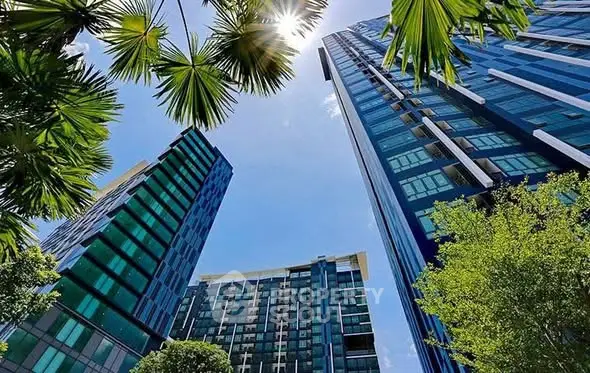 Stunning modern skyscrapers with lush greenery and clear blue sky