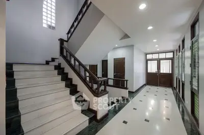 Elegant staircase and hallway with modern design and natural lighting