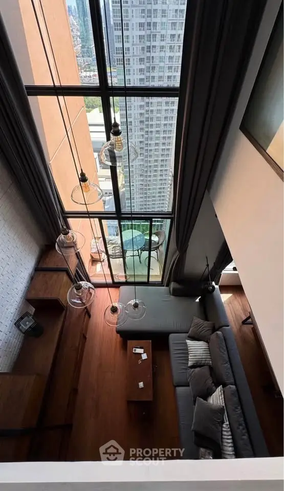 Stunning high-rise living room with floor-to-ceiling windows and breathtaking city view.