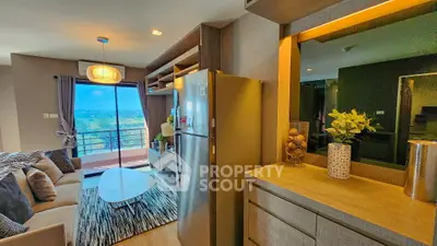 Modern living room with balcony and stylish decor, featuring a cozy seating area and scenic view.