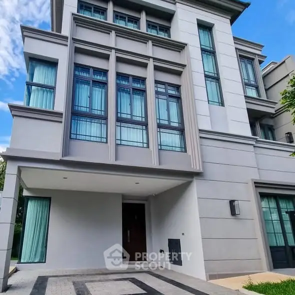 Modern multi-story building with large windows and elegant facade