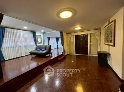 Spacious living room with elegant wooden flooring and stylish decor