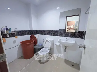 Spacious bathroom with modern fixtures and ample storage space.