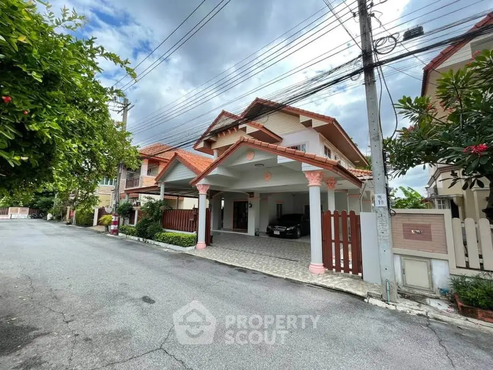 Charming suburban house with carport and lush greenery, perfect for family living in a peaceful neighborhood.