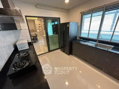 Modern kitchen with sleek black appliances and open layout design