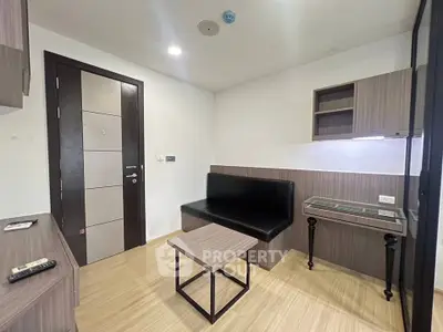 Modern living room with sleek furniture and wooden flooring in a contemporary apartment.