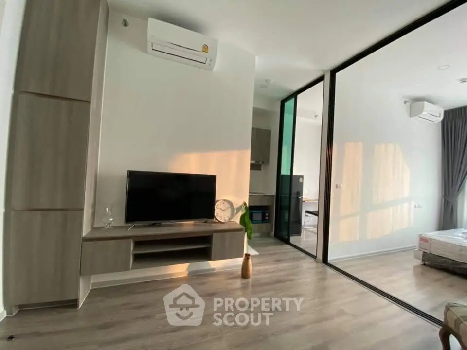 Modern living room with sleek furniture and large windows in a stylish apartment.