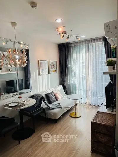 Modern living room with stylish decor and natural light in a cozy apartment.