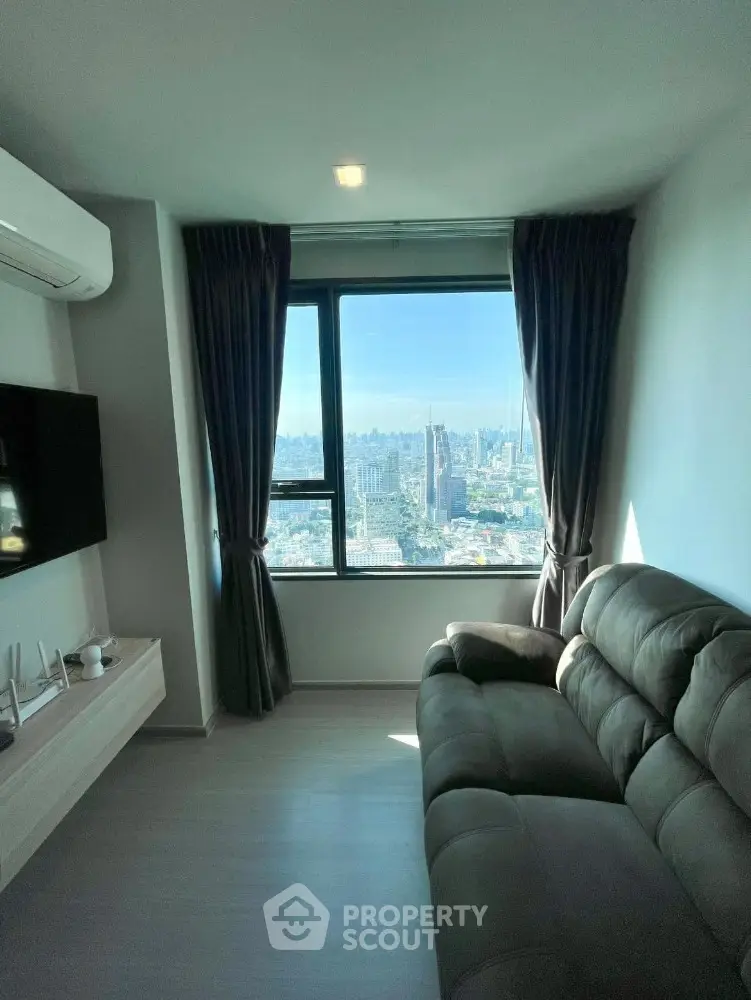 Cozy living room with stunning city view from large window, modern sofa and wall-mounted TV.