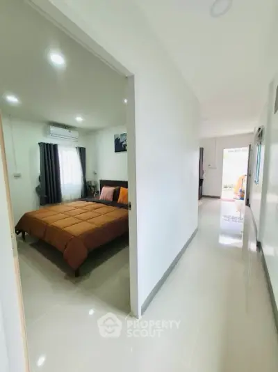 Modern bedroom with sleek design and natural light in a contemporary home.