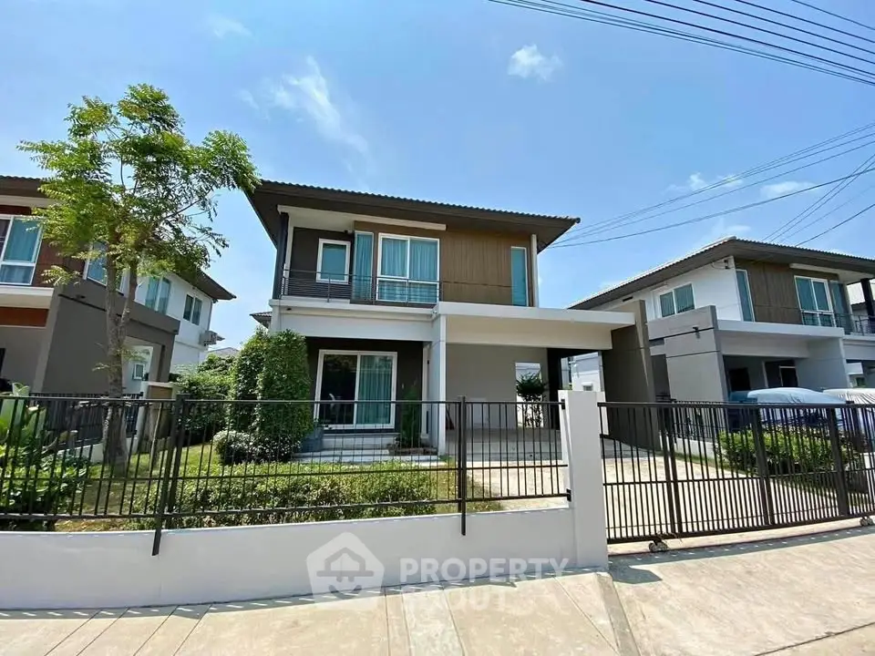 Modern two-story house with a well-maintained garden and driveway in a suburban neighborhood.