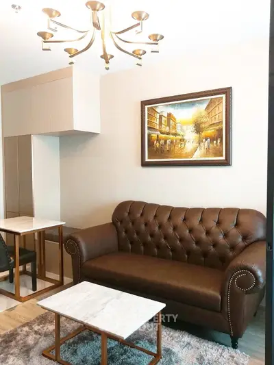Stylish living room with elegant leather sofa and modern chandelier