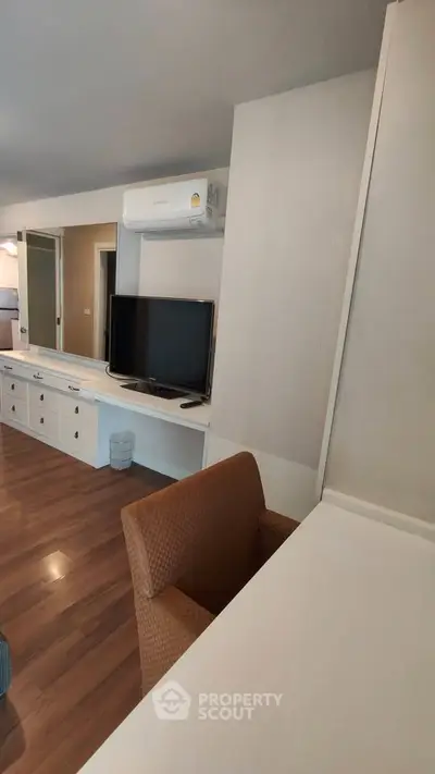 Modern living room with sleek furniture and air conditioning, perfect for comfortable living.