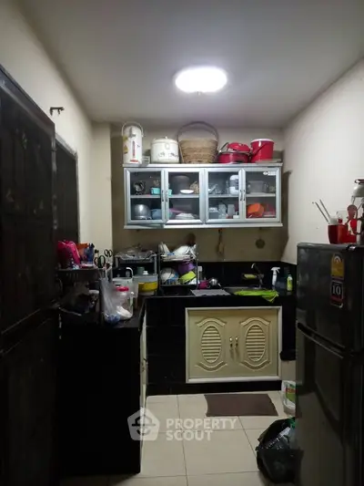 Cozy kitchen with ample storage and modern appliances, perfect for culinary enthusiasts.