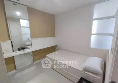 Cozy minimalist bedroom with single bed and large mirror