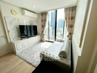 Luxurious living room with city view, elegant decor, and large TV in modern apartment.