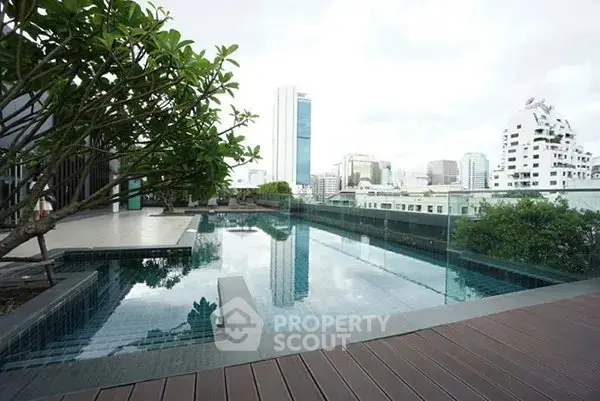 Luxurious rooftop pool with stunning city skyline view, perfect for relaxation and leisure.