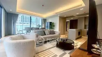 Luxurious modern living room with open kitchen and stunning city view.