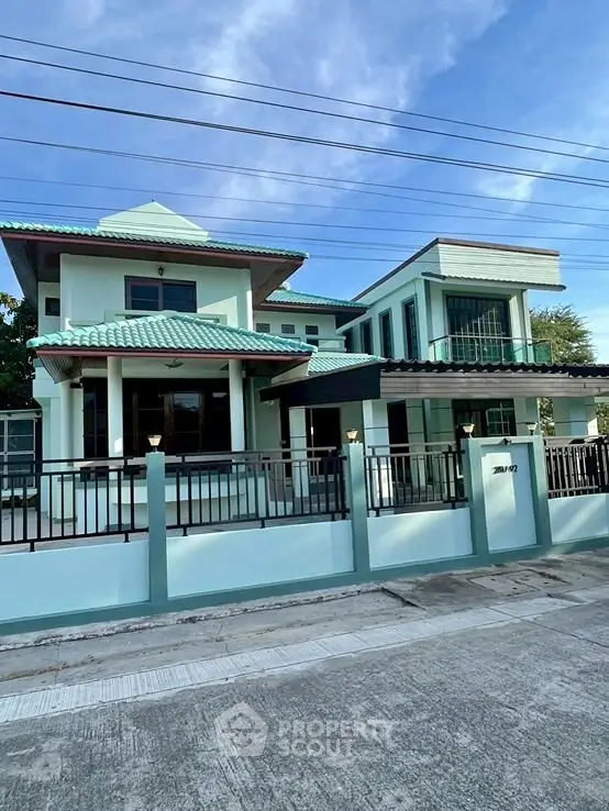 Stunning modern house with unique architecture and spacious design, featuring a stylish green roof and elegant facade.