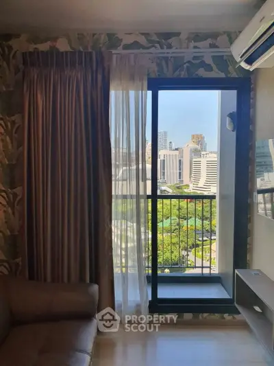 Stylish living room with city view and balcony access in modern apartment
