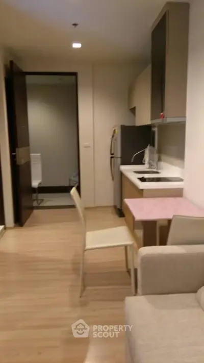 Cozy apartment kitchen with modern appliances and dining area
