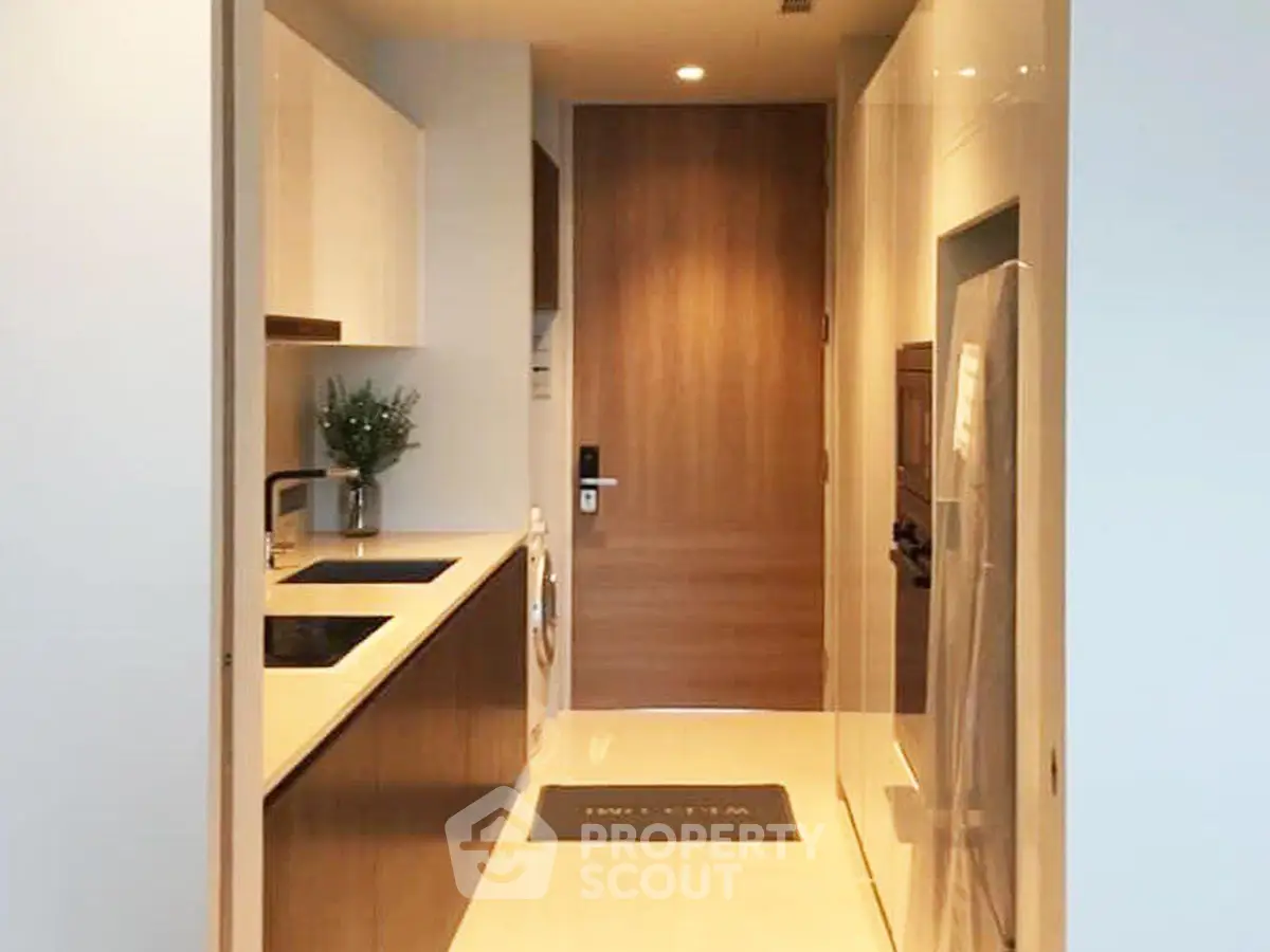 Modern kitchen with sleek cabinetry and built-in appliances in a stylish apartment.