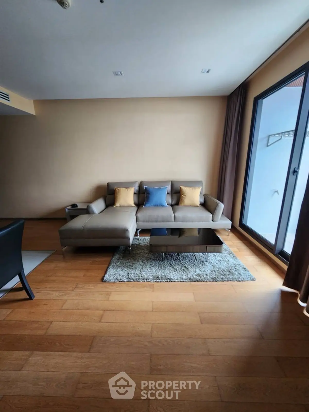 Spacious living room with modern sofa and large window for natural light.