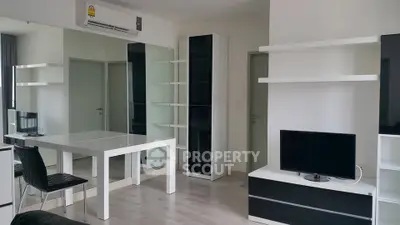 Modern living room with sleek furniture and air conditioning unit
