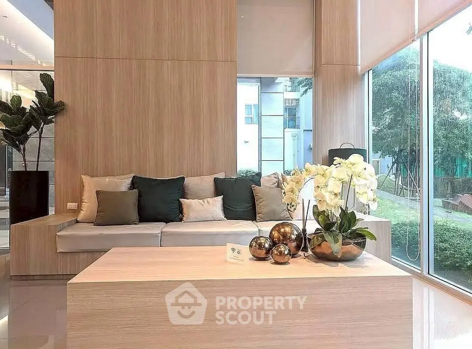 Modern living room with large windows and elegant decor in a luxury apartment.