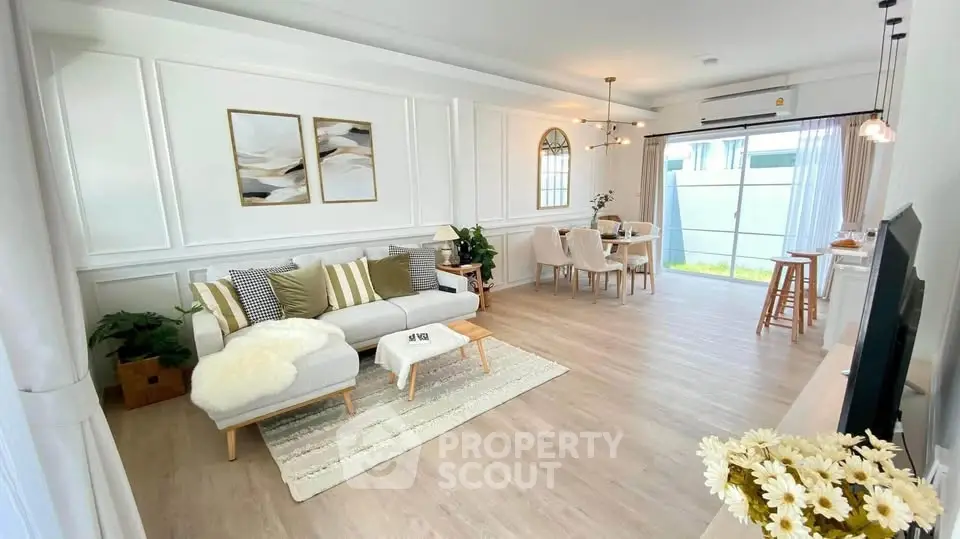 Spacious and elegantly designed living room with modern decor and ample natural light.