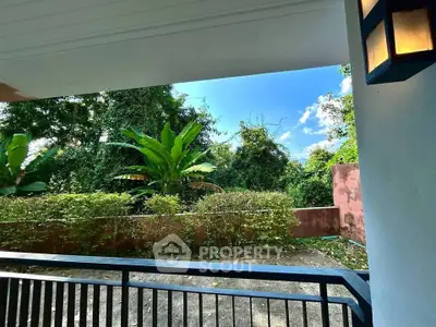 Charming garden view from a cozy balcony, perfect for relaxation and enjoying nature.