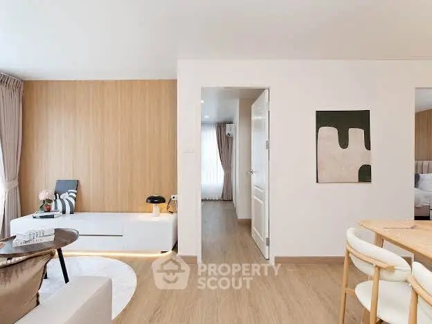 Modern living room with wooden flooring and stylish decor in a cozy apartment.