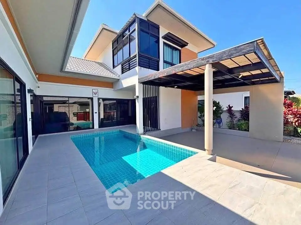 Modern two-story home with private pool and spacious patio, perfect for luxury living.