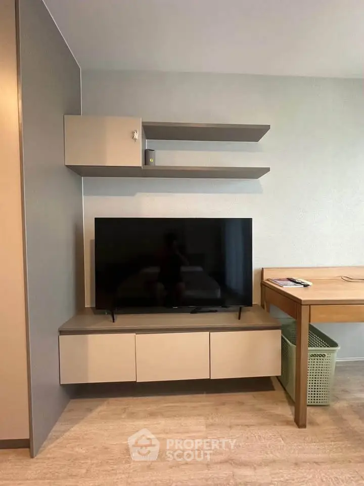 Modern living room with sleek TV stand and wall shelves, perfect for contemporary urban living.
