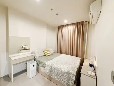 Cozy bedroom with modern furnishings and soft lighting, perfect for relaxation.