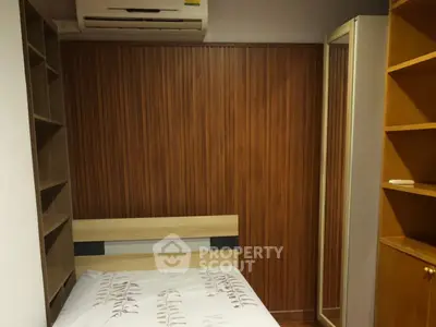 Cozy bedroom with wooden paneling and built-in storage solutions