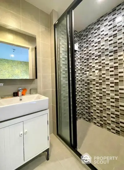 Modern bathroom with stylish tile shower and sleek vanity