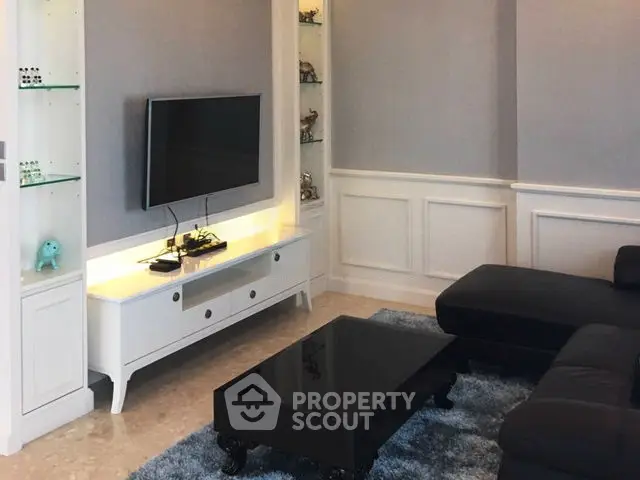 Elegant living room with modern TV setup and stylish furniture